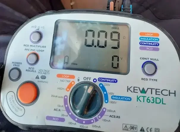 Doing EICR's & Landlord certificates in Banbury RW Currion Electrical technician testing an electrical socket at a residential property